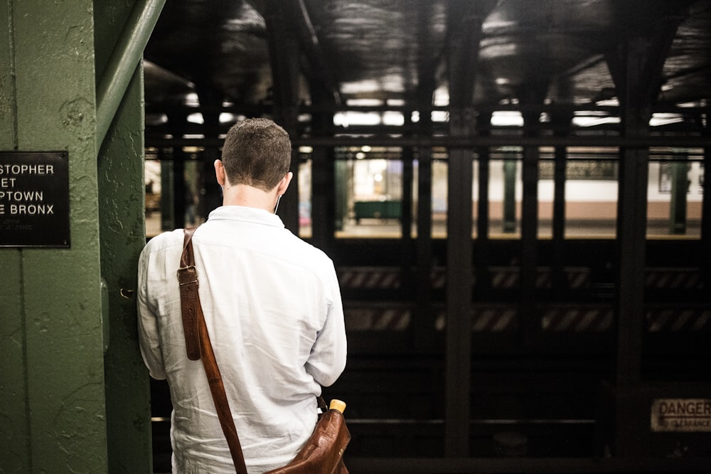 man wearing white dress shirt with crossbody bag