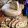 Close-up of a rustic wooden table with slices of natural cheese and fresh bread.