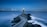 gray lighthouse on islet with concrete pathway at daytime