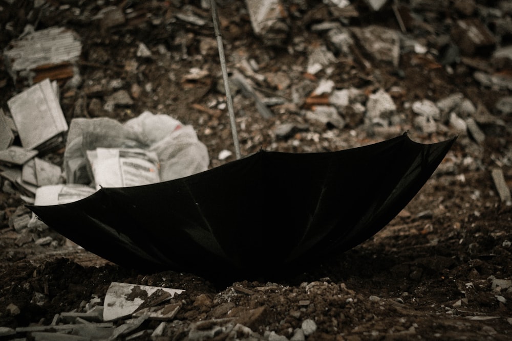 black umbrella on soil ground