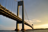 gray metal bridge across body of water