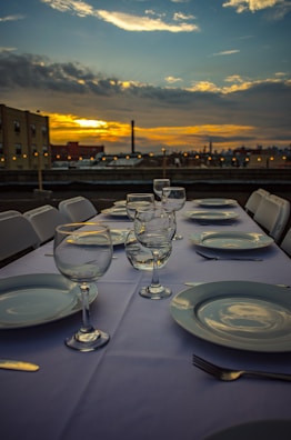 A beautifully set outdoor dining table with iconic São Paulo cityscape in the background.