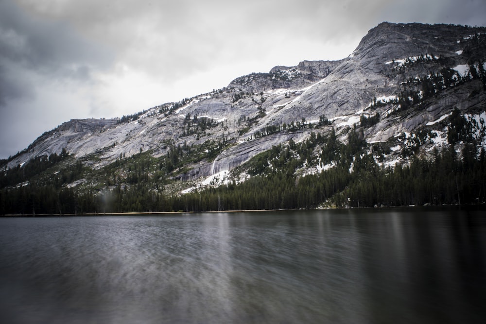 long exposure photo of body of water and mountains