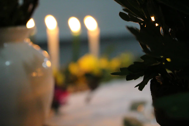 Candles softly glowing on a table, symbolizing hope and prayer support.