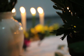 Candles softly glowing on a table, symbolizing hope and faith.