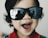 A happy child wearing a stylish minikids accessory.