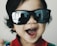 A happy child wearing a stylish minikids accessory.