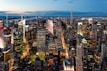 An abstract view of a bustling city skyline at dusk with neon lights.
