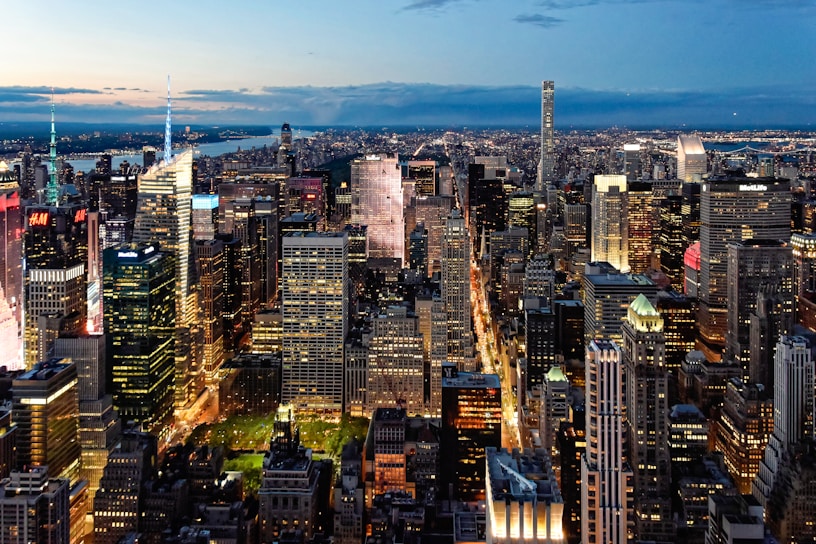 A vibrant city skyline at dusk with glowing office windows symbolizing modern business energy.