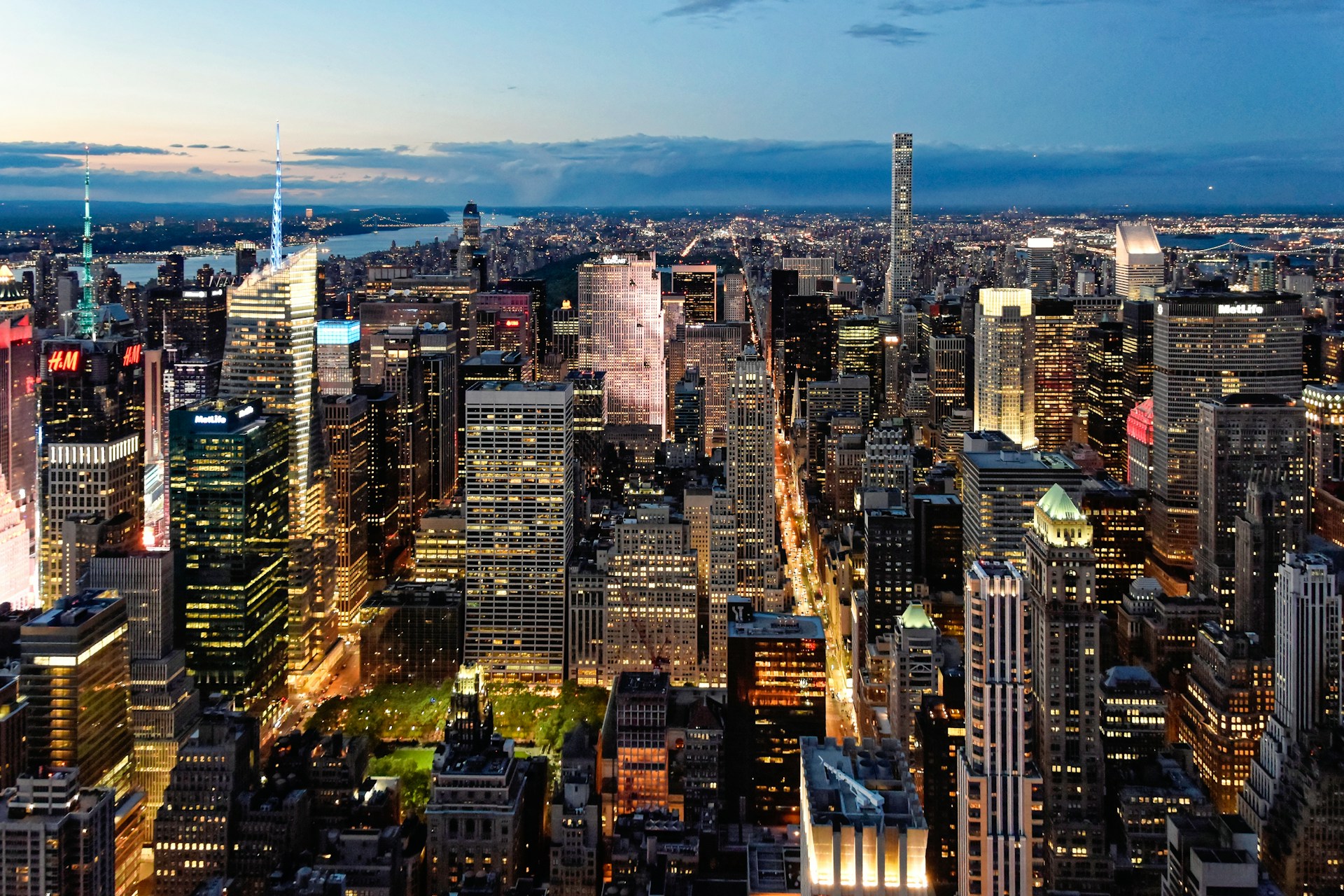 A vibrant cityscape at dusk showcasing dynamic architectural lines and glowing windows.