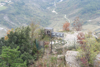 A group of local volunteers inspecting a tracking station in an urban garden.