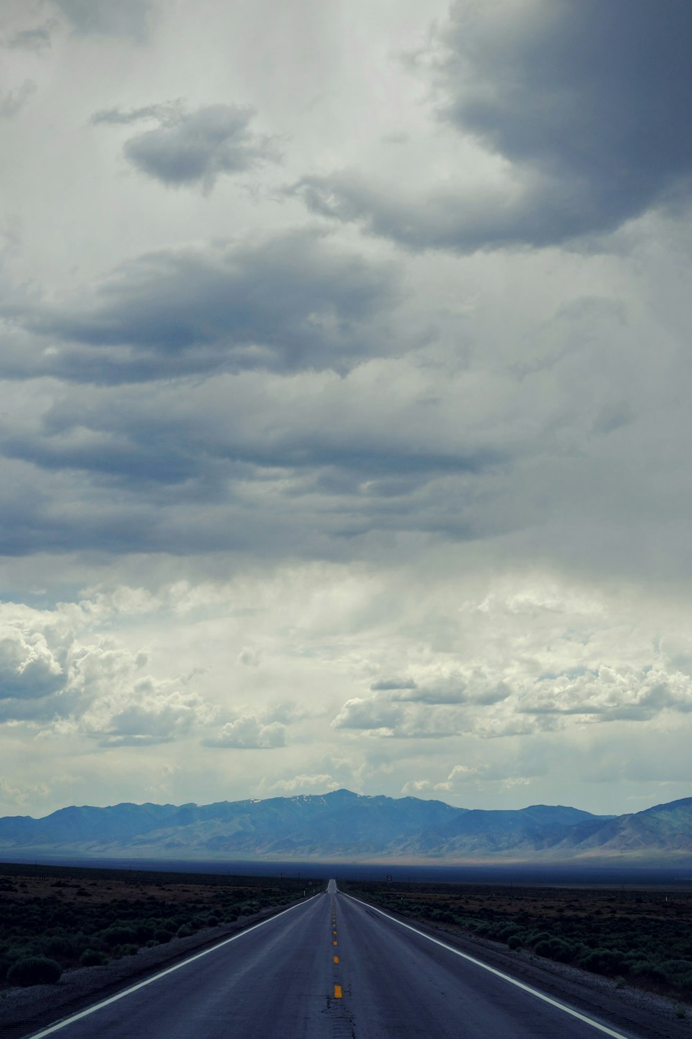 white clouds over green mountains during daytime