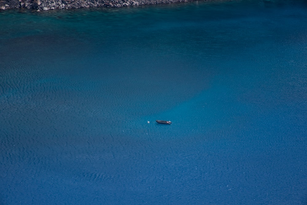 a small boat floating in a large body of water