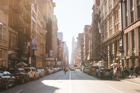 person walking on road beside cars in Broadway United States