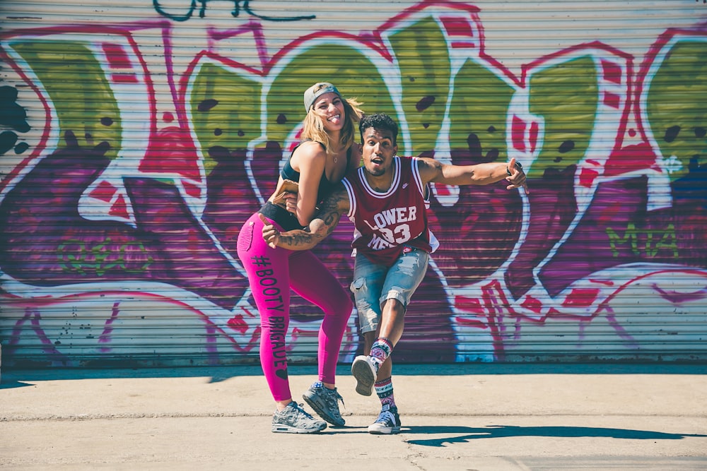 man beside a woman taking a photo