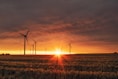 windmill on grass field during golden hour