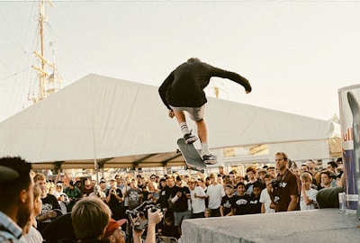 Skateboarders gathered together celebrating after a competition event.