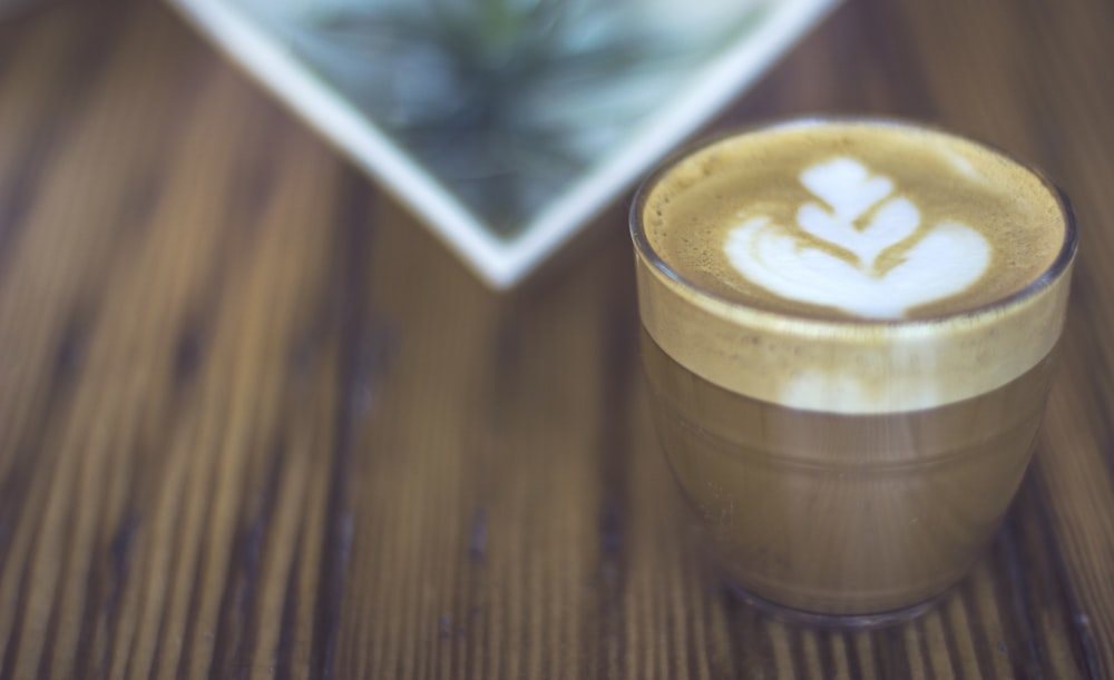 macro photography of latte in drinking glass