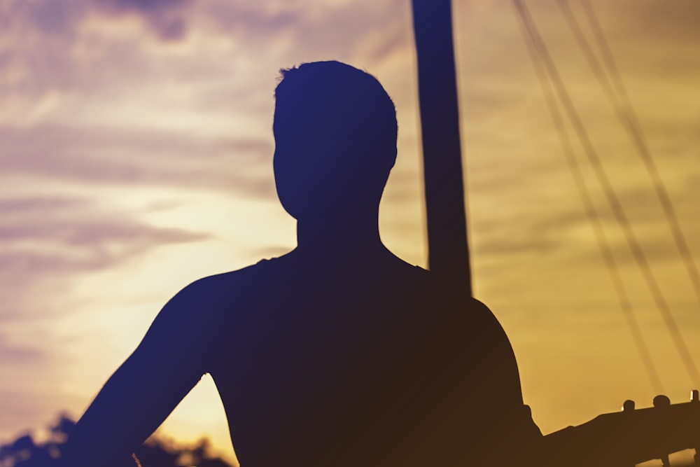 man in front of post during day