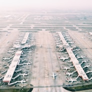 Aerial view of a busy airport with planes and fueling trucks in Maranhão