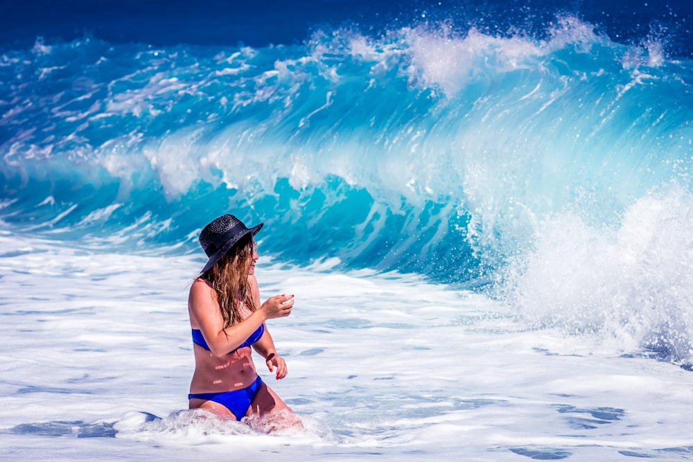 woman standing in front of water waves
