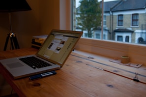 Technician carefully installing Windows operating system on a laptop in a cozy home office