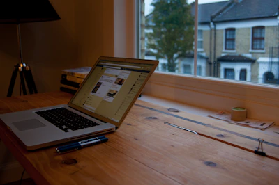 A student using a lightweight refurbished laptop in a cozy home study space with natural light.