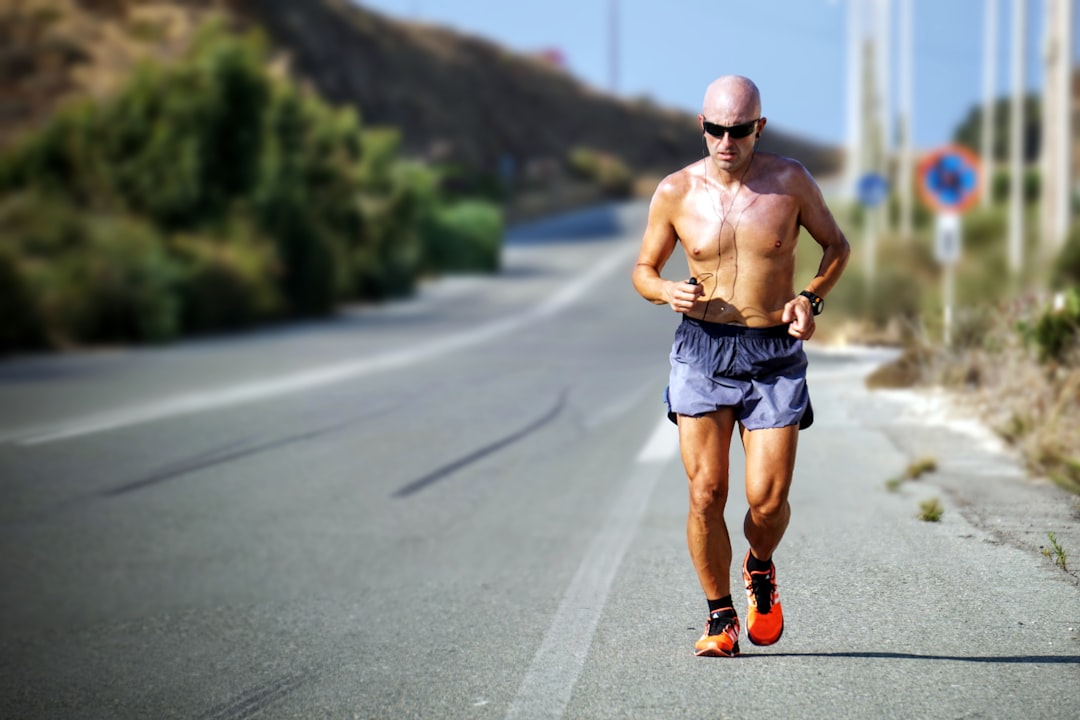 man jogging while listening using black earphones during day time, Don’t stop me now