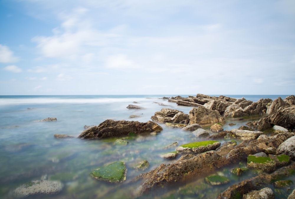 photo rocky beach during daytime