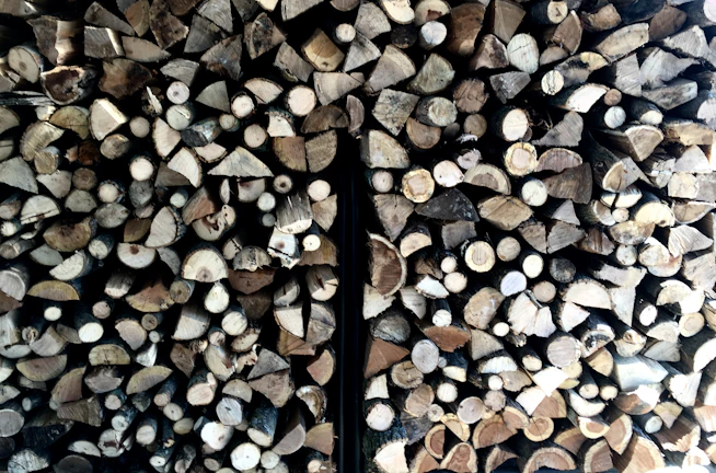 Close-up of wooden pellets neatly piled in a rustic storage.