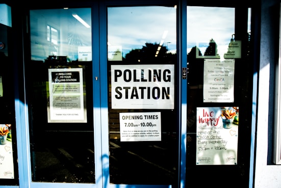 polling station poster on clear glass door