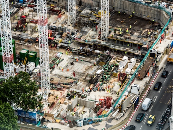 A busy construction site with cranes and building materials.