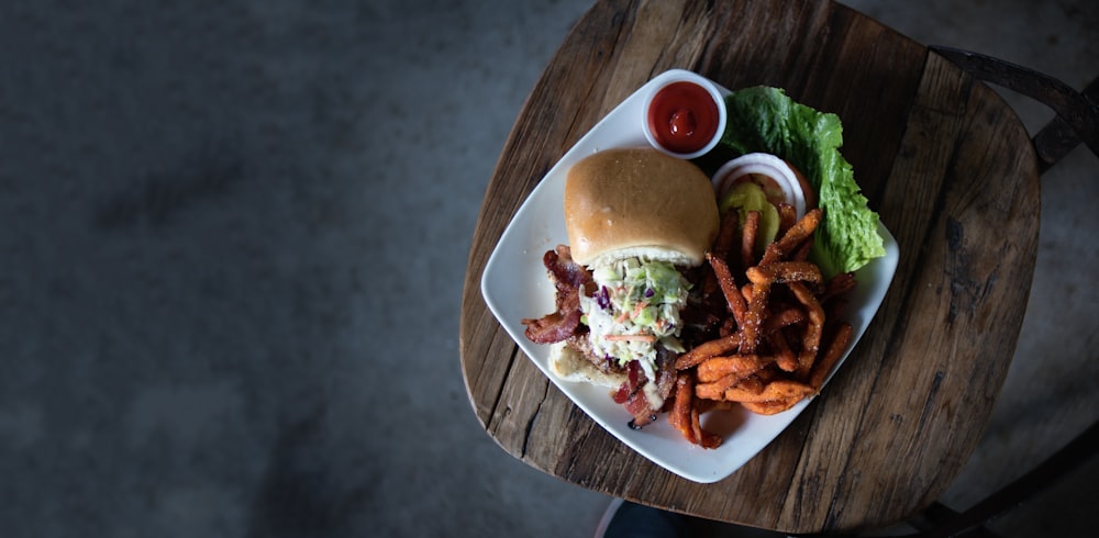 Hamburger und Pommes auf Keramikteller