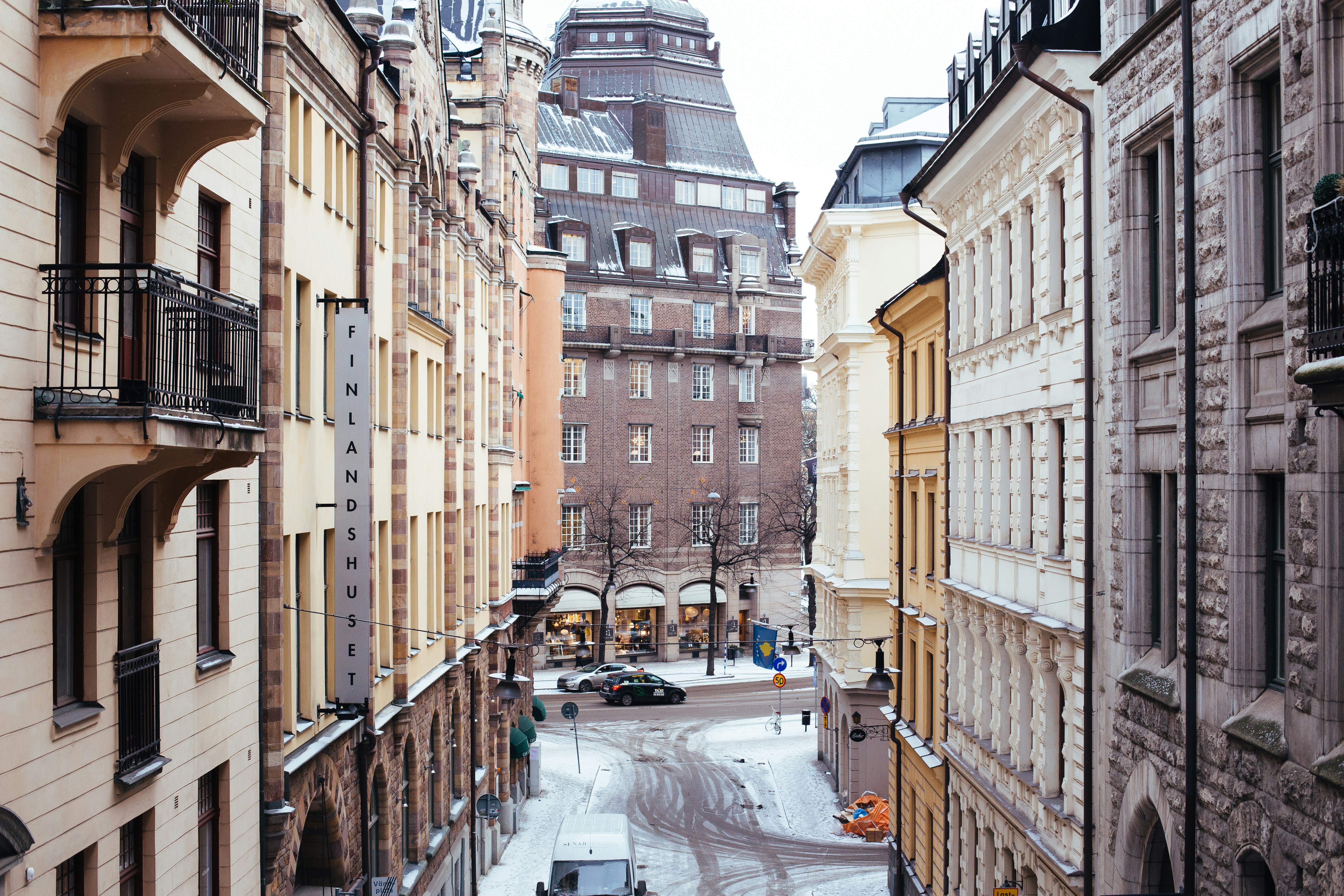 beige and black Finland Sunset building, Snowy stockholm street
