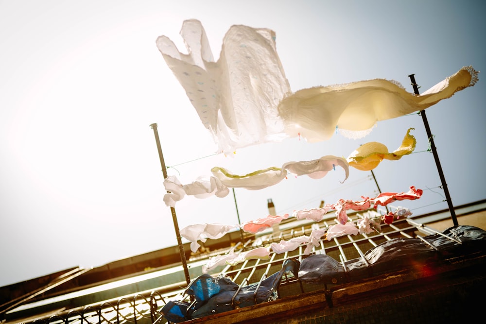 low-angle photography of hanging clothes outside house during daytime