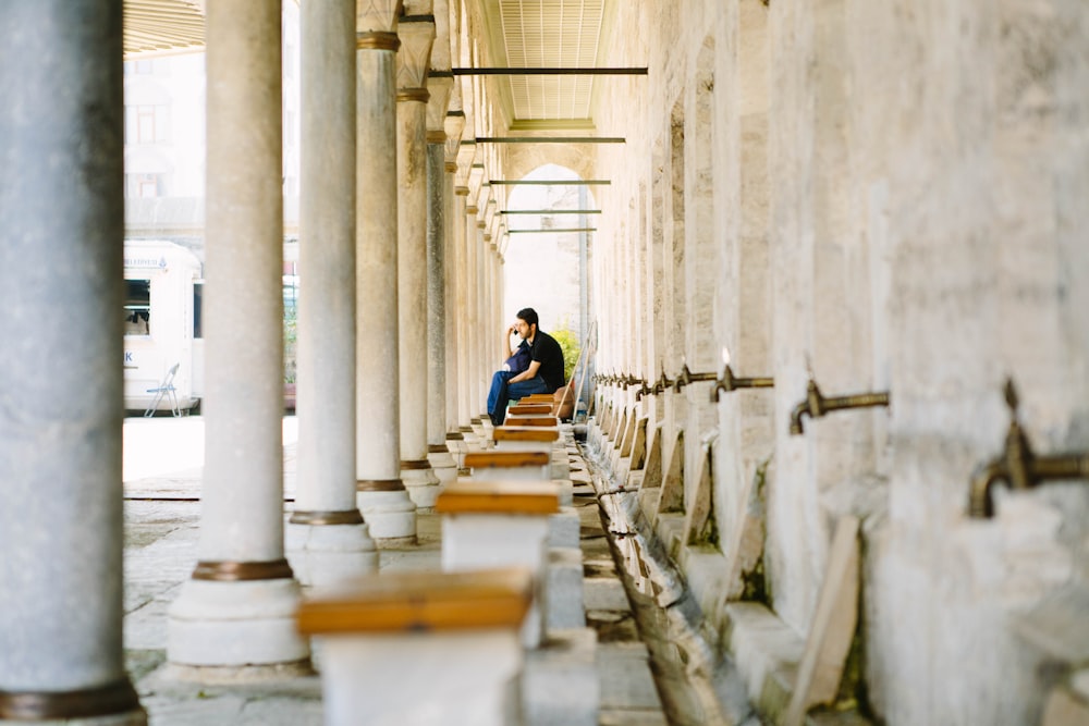 a man sitting on a bench in a building