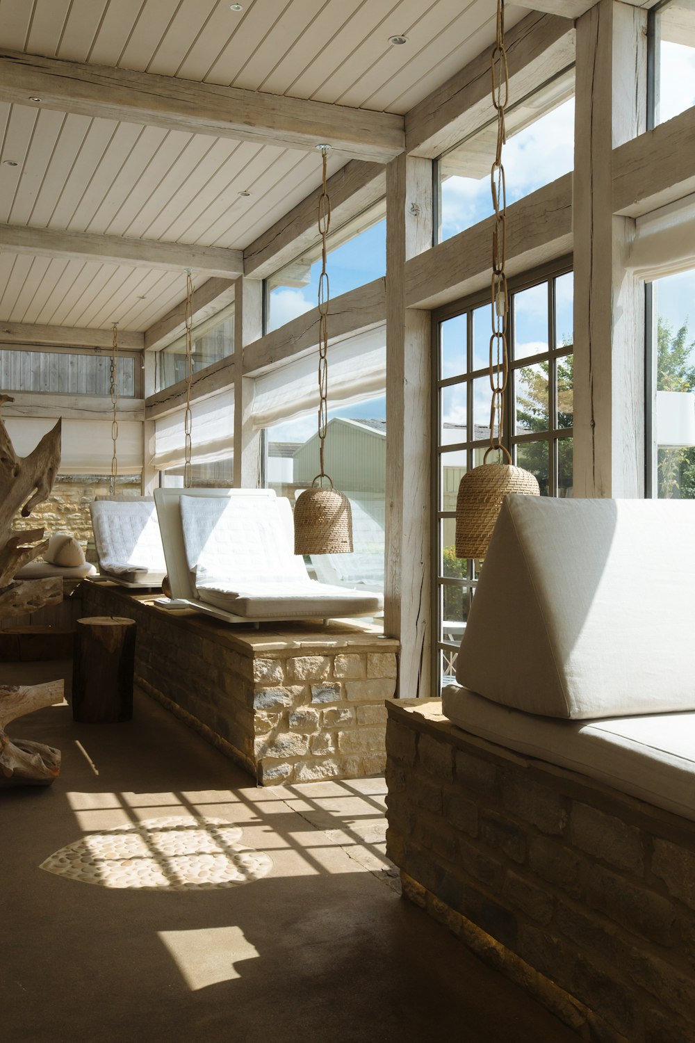 a living room filled with furniture and windows