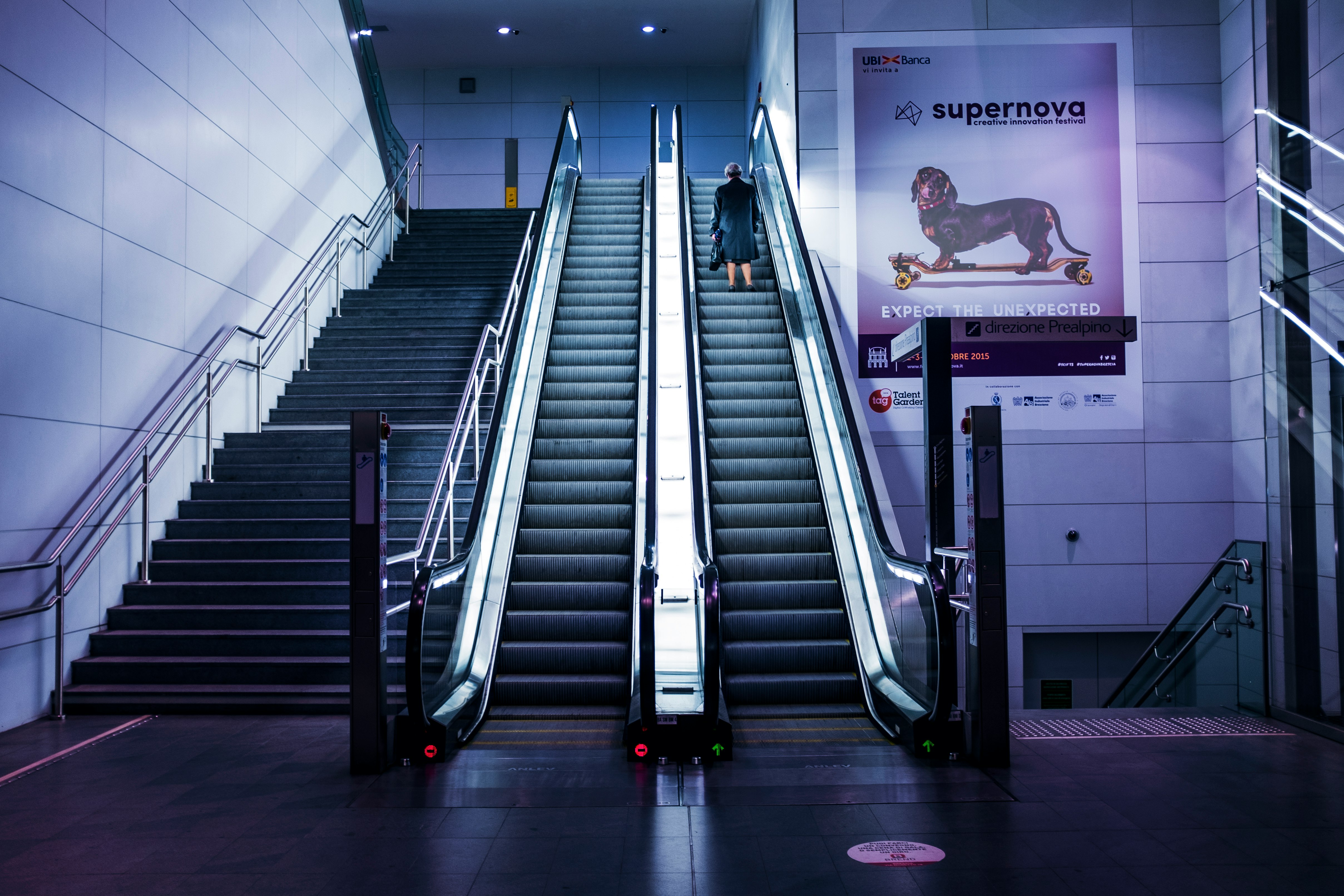 woman standing on escalator