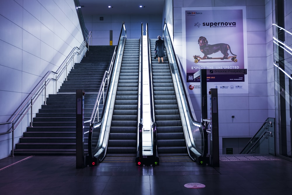 woman standing on escalator