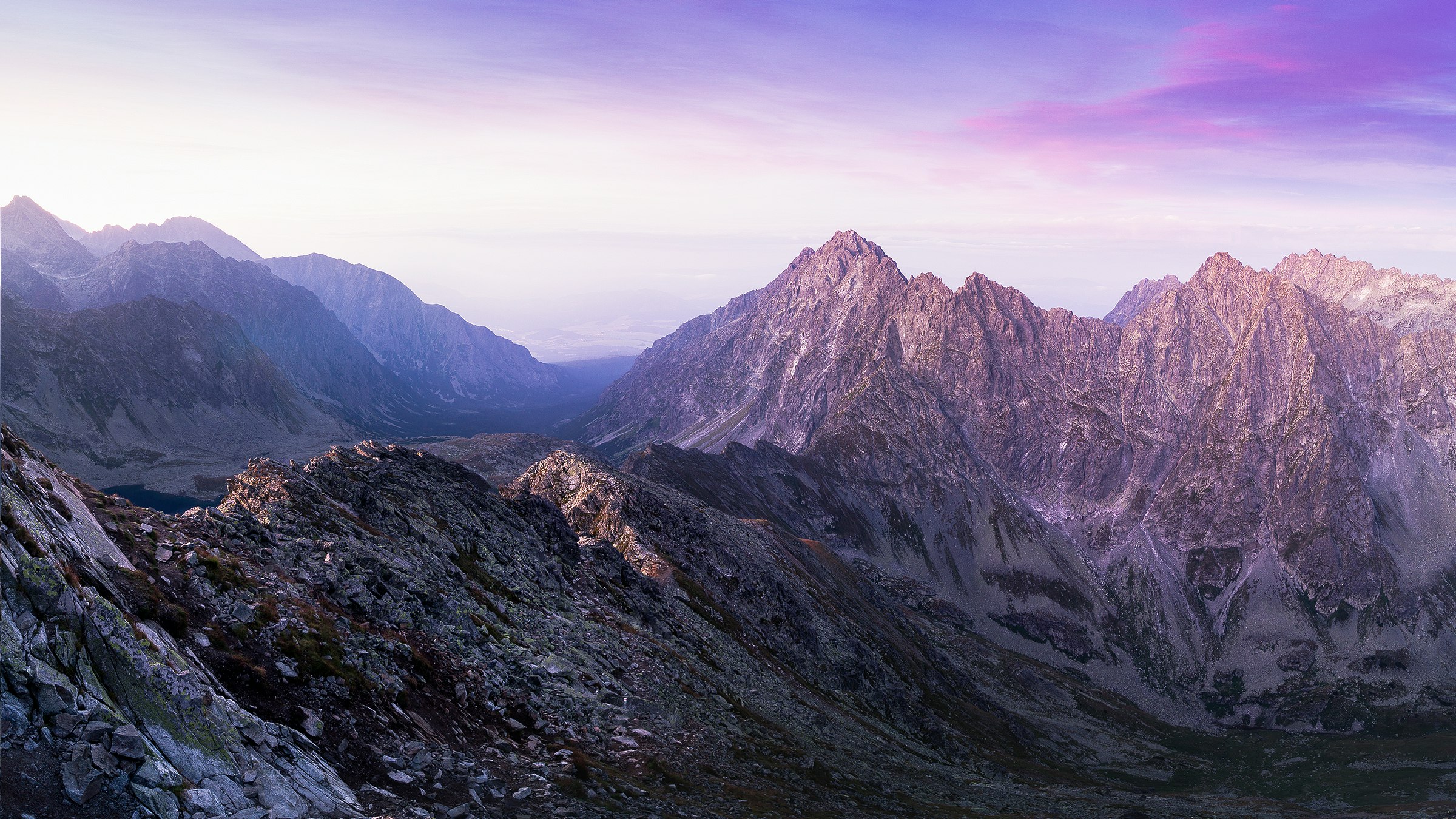 landscape photography of mountain ranges under purple and pink skies