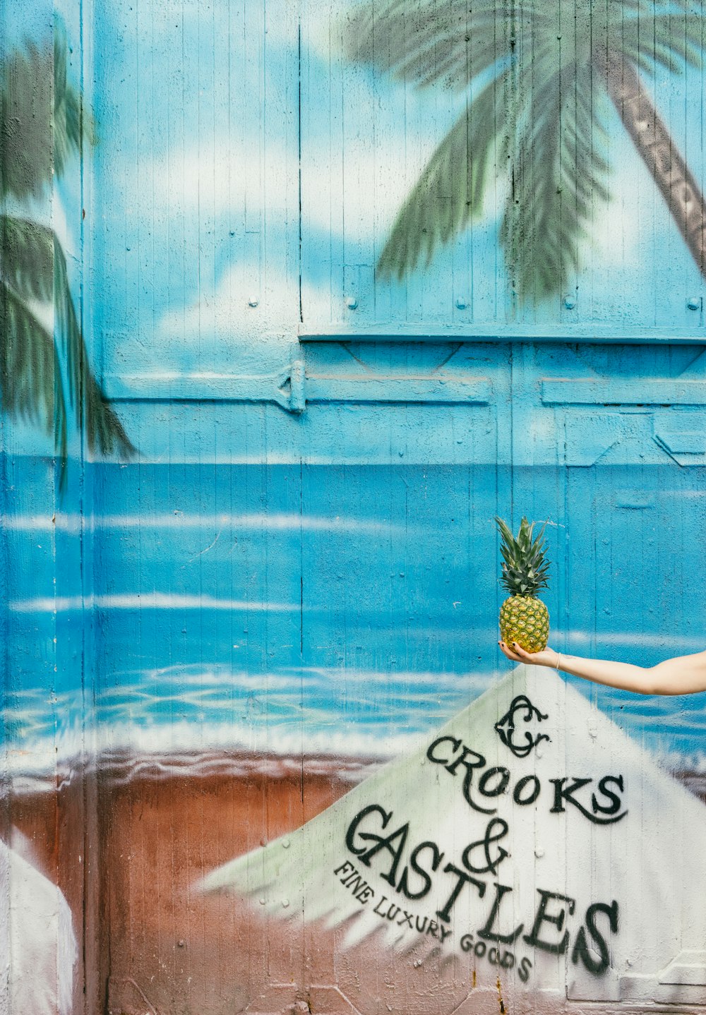 Mural painting of a pineapple on the beach.