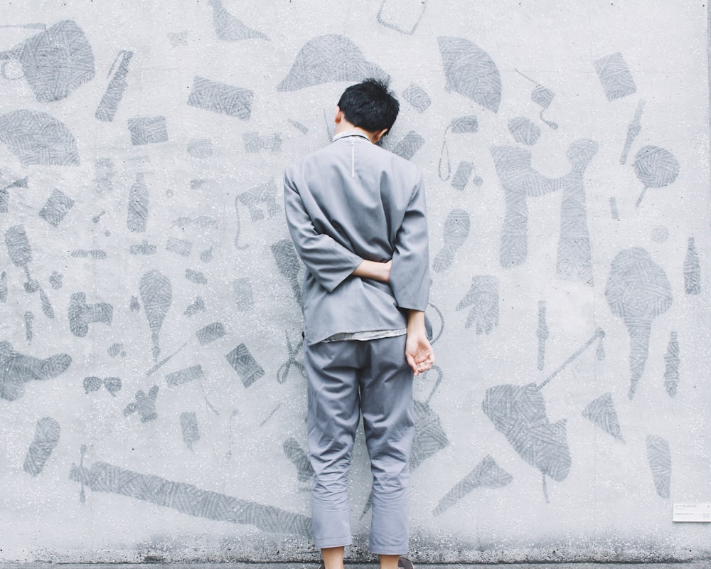 man standing in front of wall