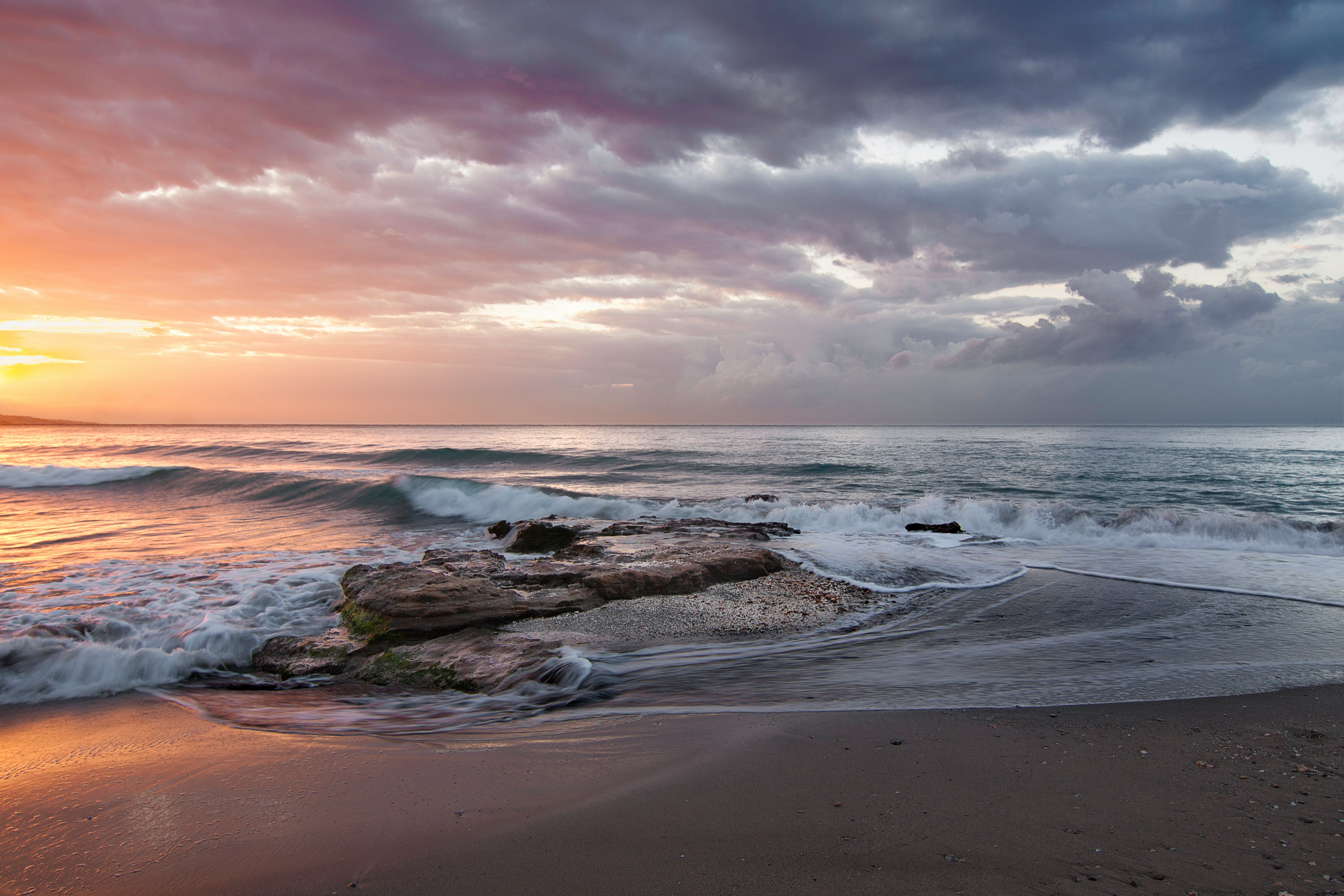 Stormy orange beach sunrise