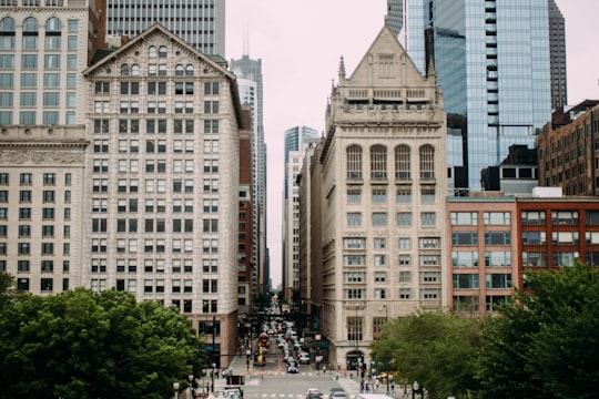 photo of white and brown concrete building during daytime in Millennium Park United States