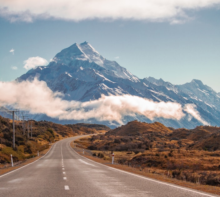 grey road in behind mountain