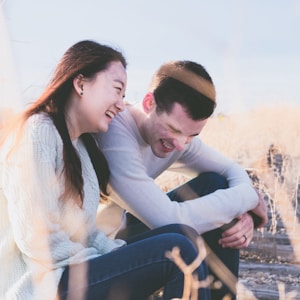 photo of man and woman laughing during daytime