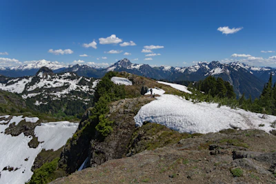 A scenic international mountain landscape with hikers enjoying the view.