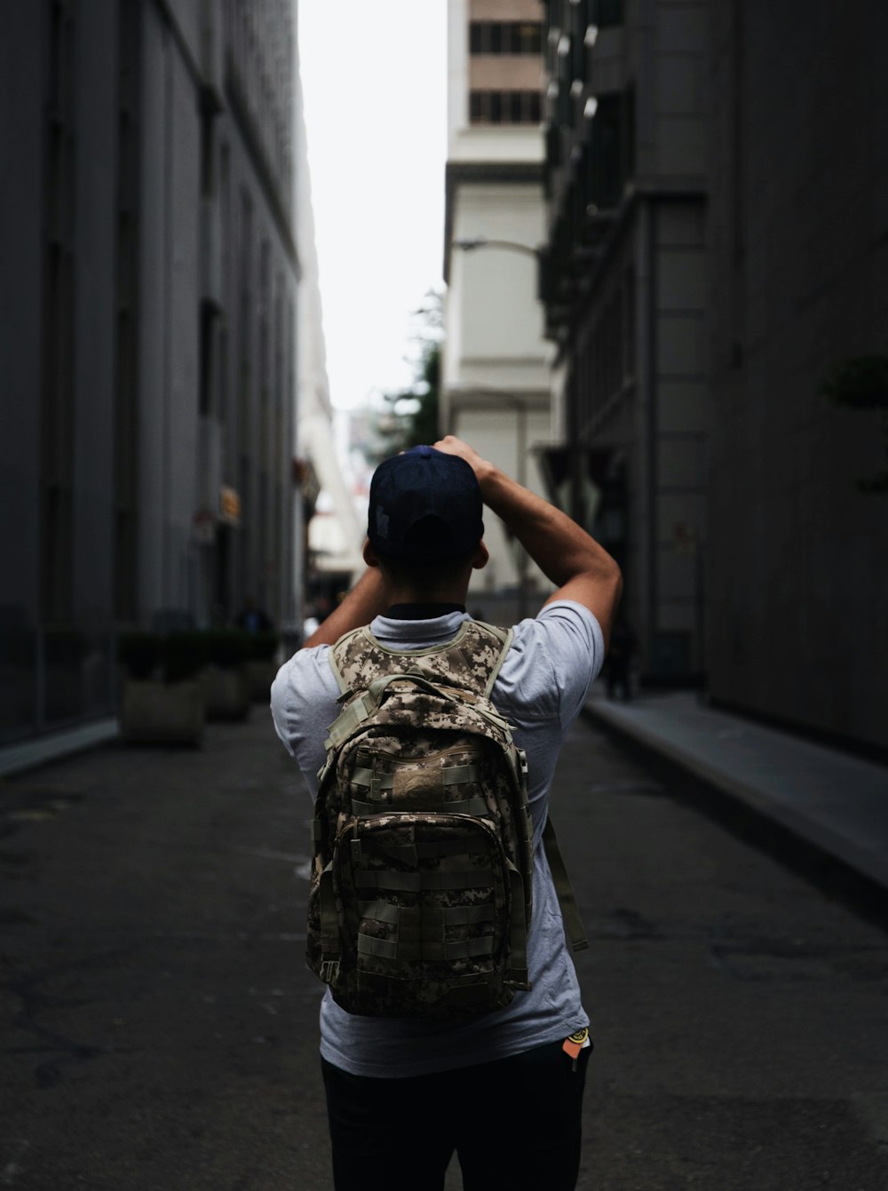 man standing between two buildings