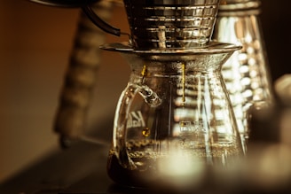 Close-up of a sleek drip coffee maker brewing a fresh pot of coffee in a cozy kitchen setting.