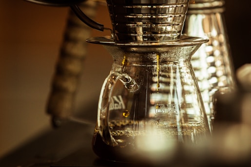 Close-up of a sleek drip coffee maker brewing a fresh pot of coffee in a cozy kitchen setting.